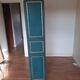 Glass-fronted cabinet in weathered green wood