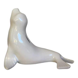 White earthenware sea lion in piggy bank