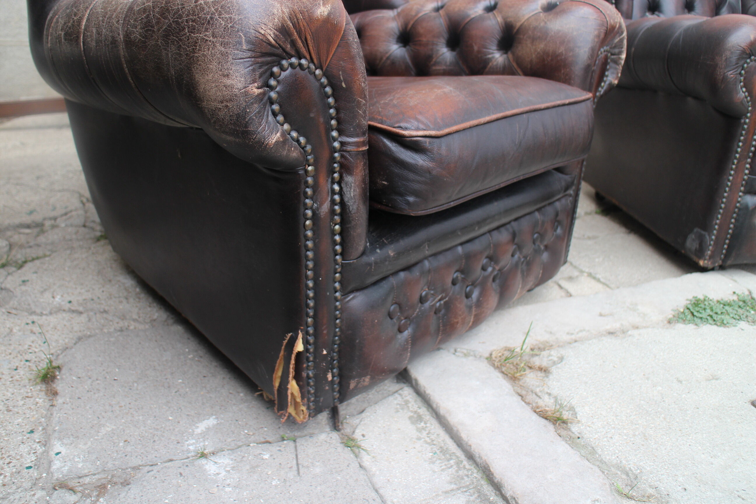 Padded chesterfield leather armchairs
