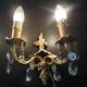 Pair of gilt bronze wall sconces with crystal pendants.