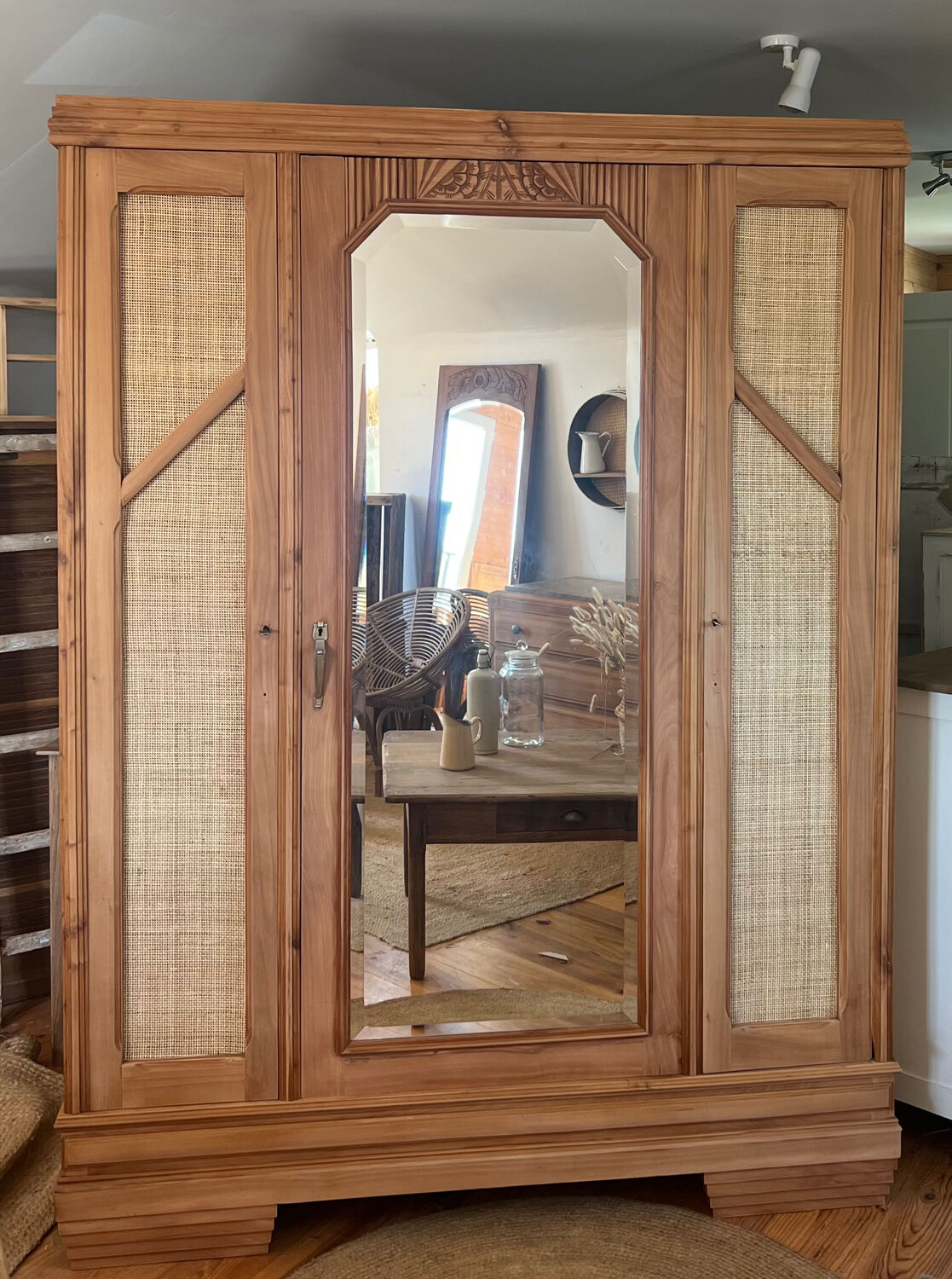 Large antique wardrobe made of solid raw wood and natural caning.