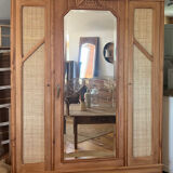 Large antique wardrobe made of solid raw wood and natural caning.