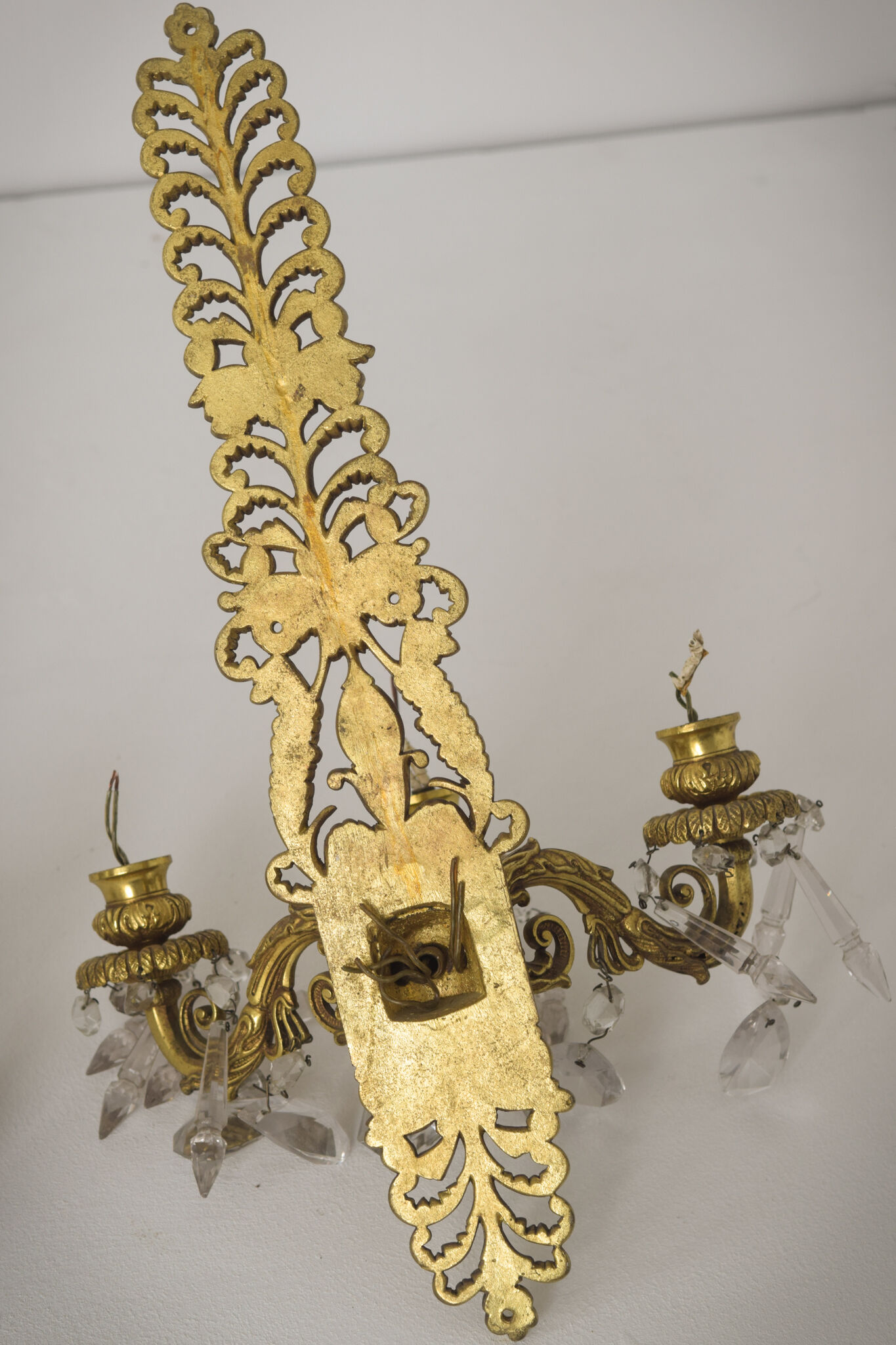 Two bronze and cut glass wall-mounted chandeliers