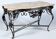 Wrought iron table with openwork flower belt. marble top