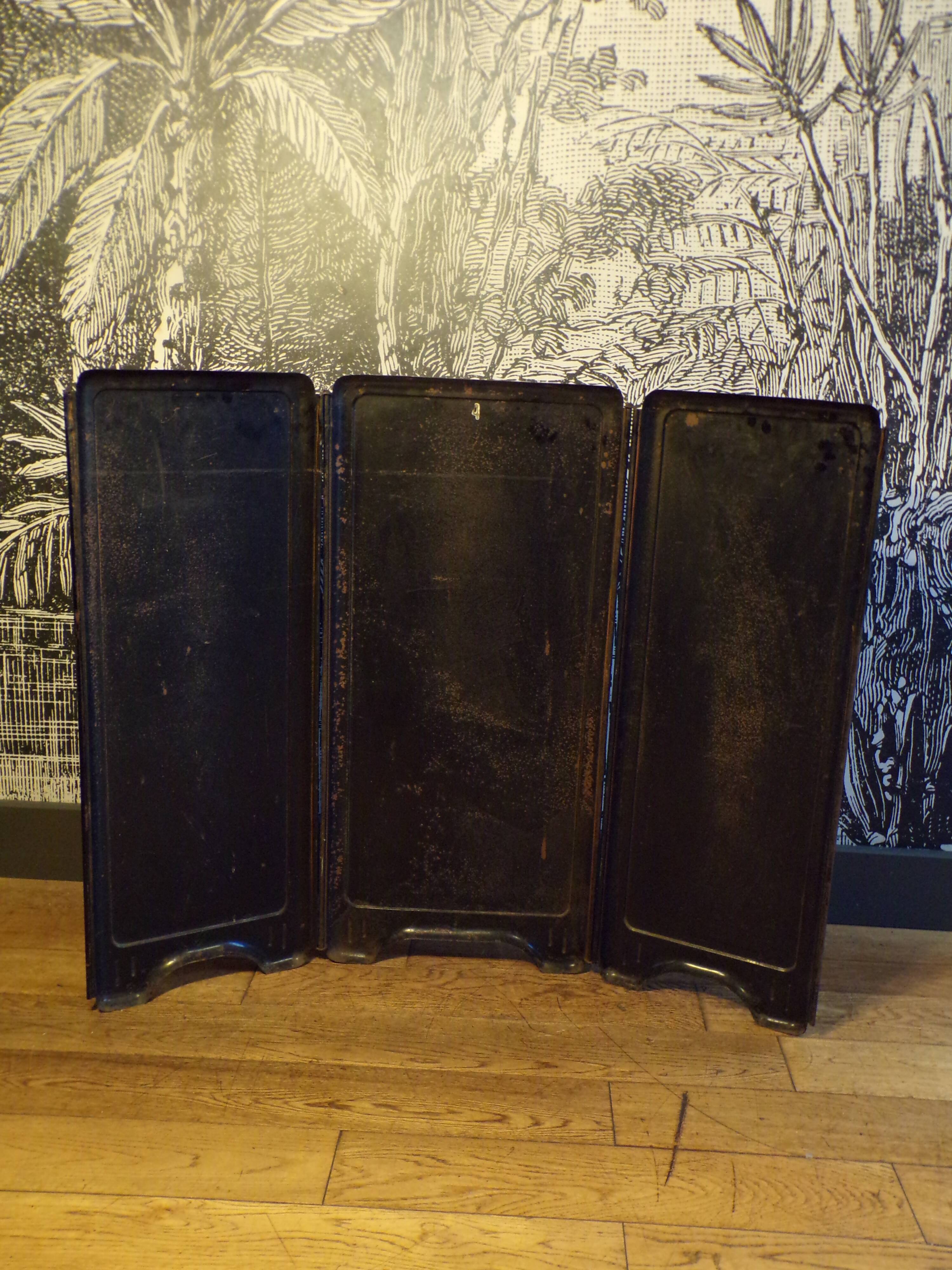 Old fireplace screen in painted sheet metal