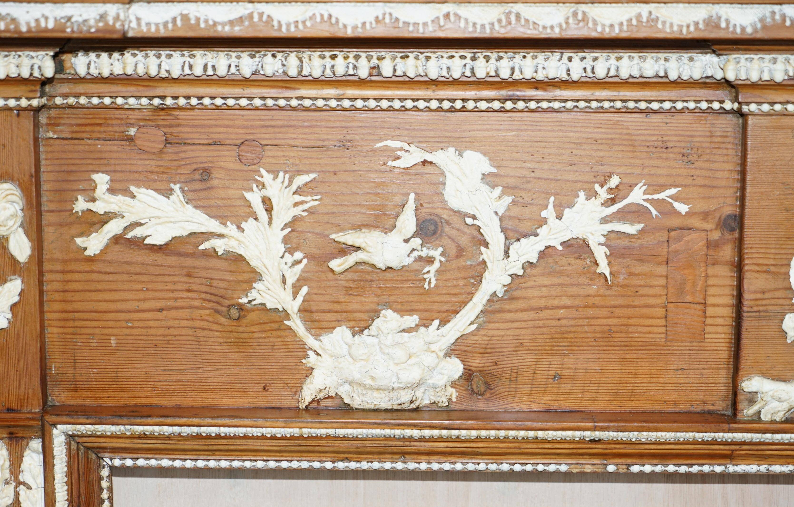 Victorian antique fireplace in tarred pine and sculpted gesso.
