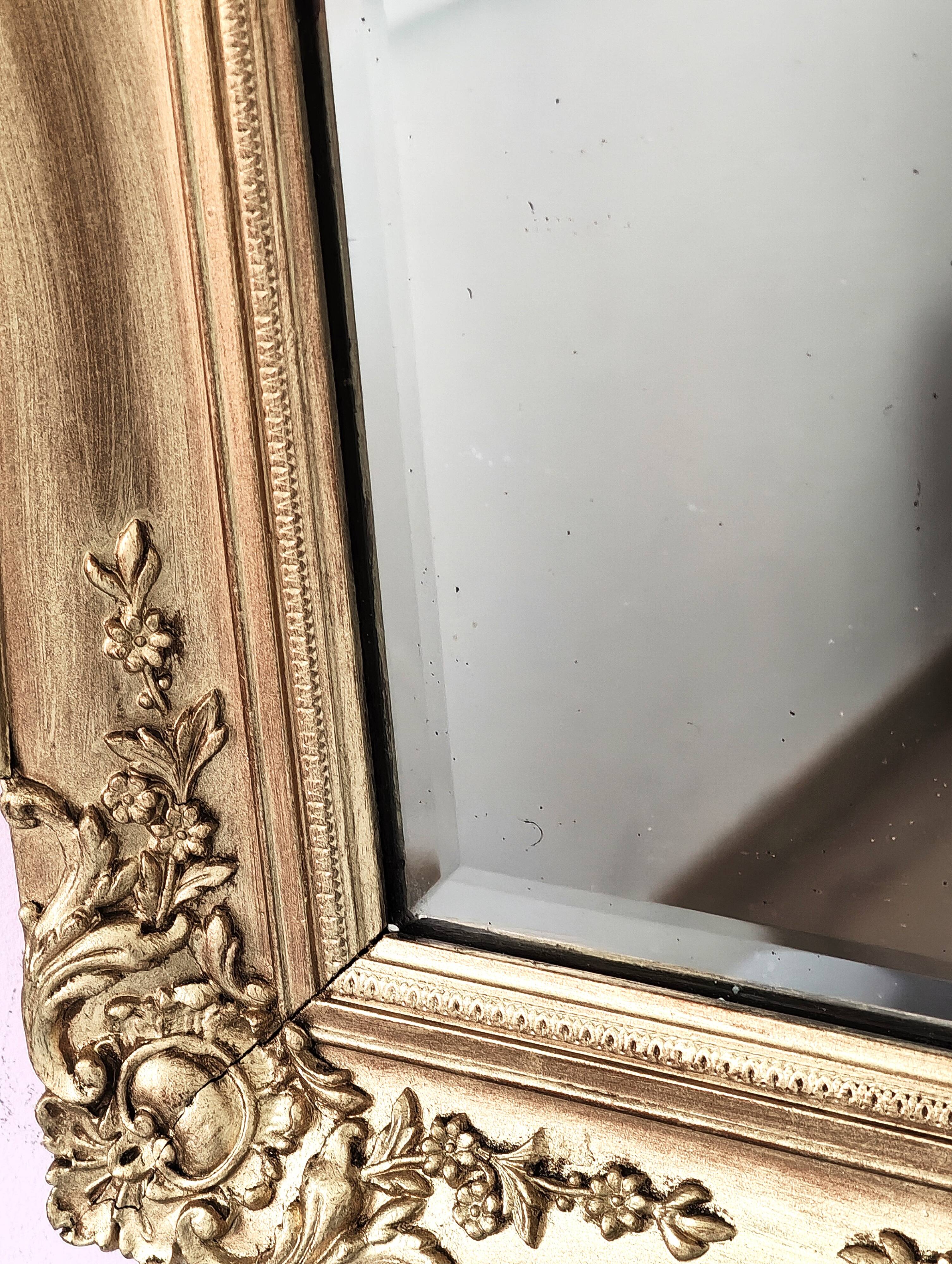 Richly carved antique gilded mirror