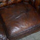 Victorian Chesterfield leather upholstered canapé with feather cushions.