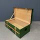 Green metal trunk with wooden sleds