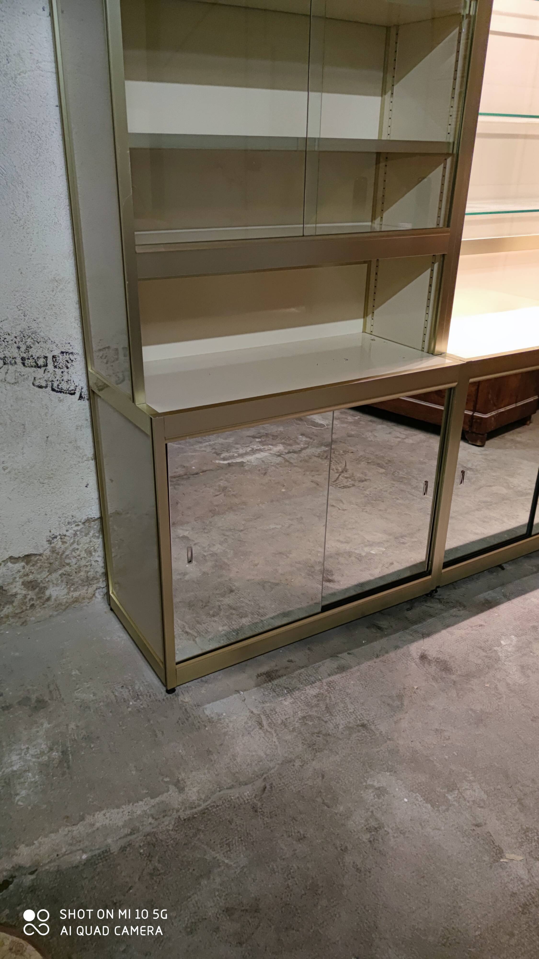 Ivory-colored and matte gold anodized aluminum display bookcase