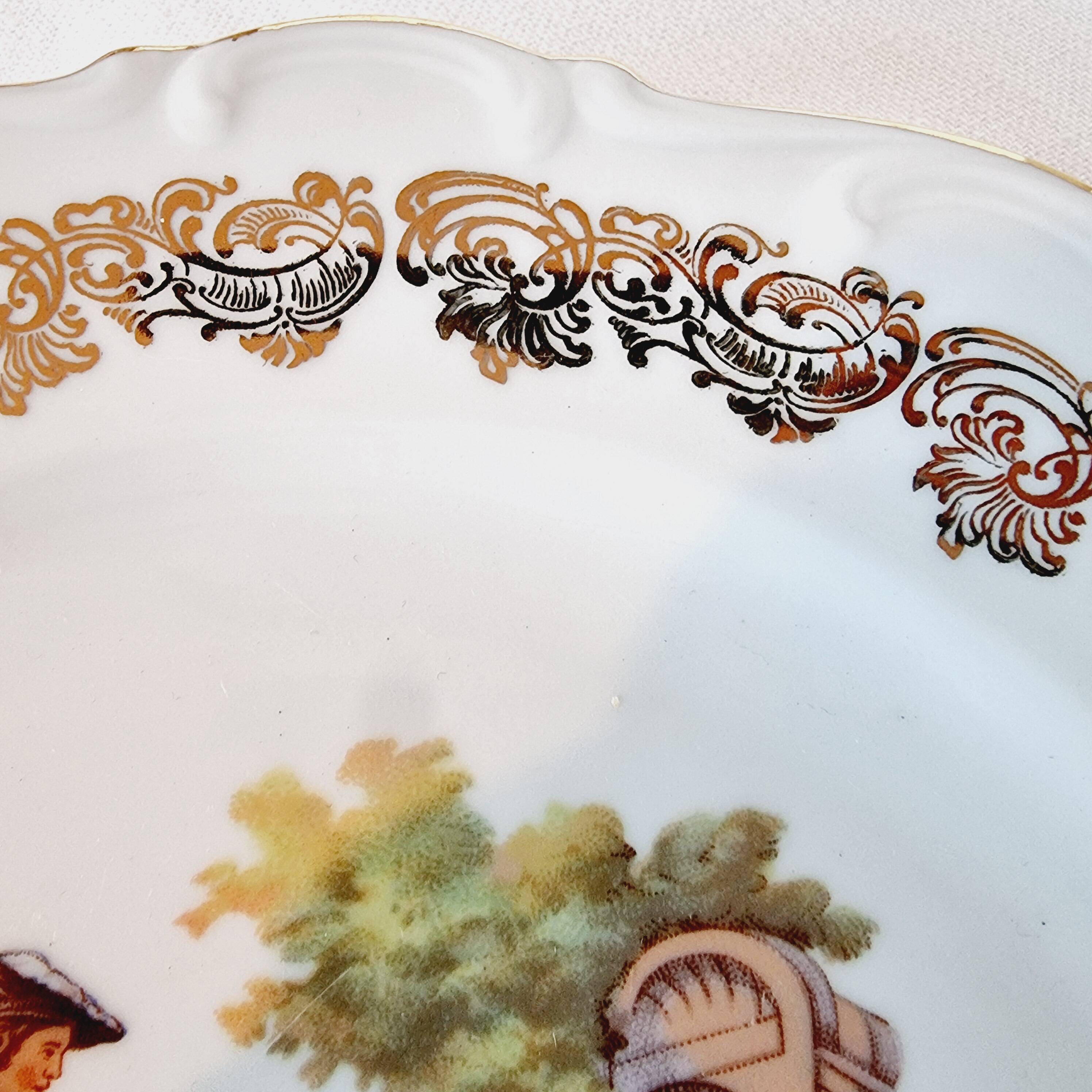 Large serving plate with romantic Frangonard scene with 24 carat gold