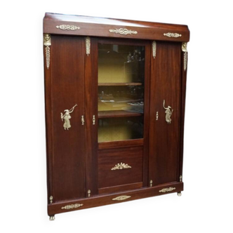 Empire style mahogany display bookcase with gilt bronze decoration and three doors.