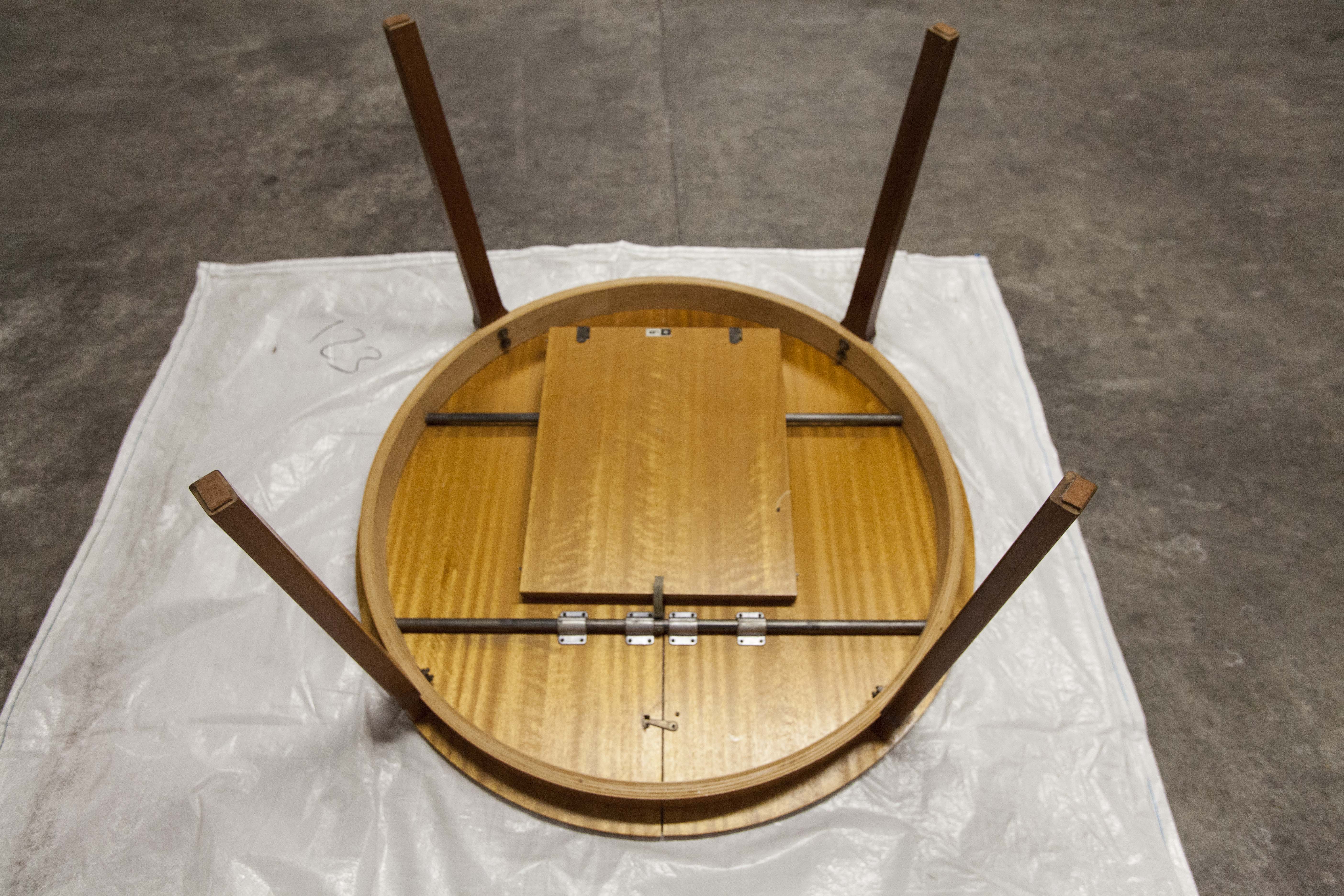 Scandinavian table in round teak with built-in extensions 1960