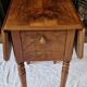 Nineteenth-century walnut work table with flaps, large storage + secret drawer.