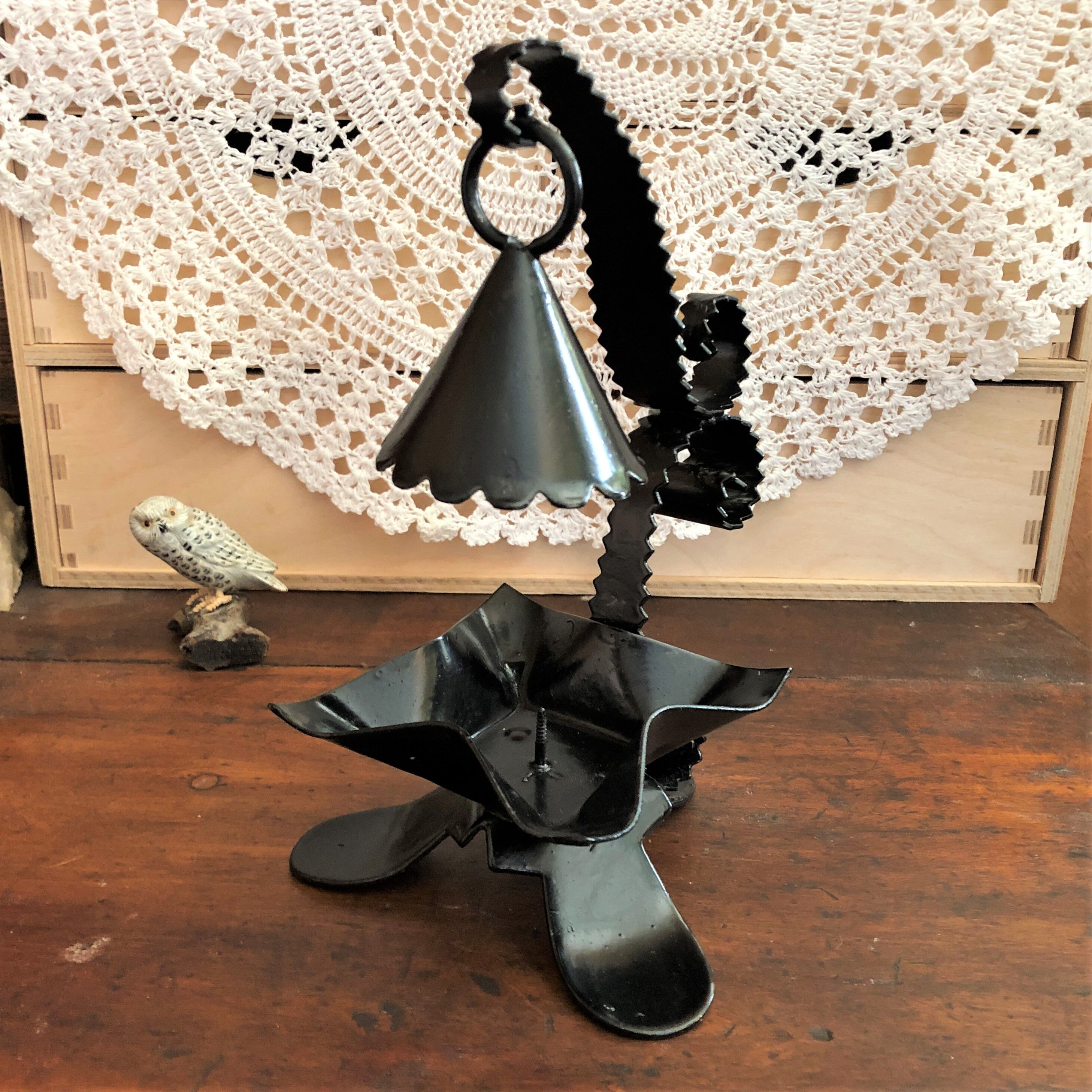 Handcrafted black wrought iron candle holder with its vintage extinguisher