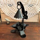 Handcrafted black wrought iron candle holder with its vintage extinguisher