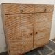 Vintage woven rattan furniture with tapered legs.