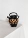 Old vase in glossy black ceramic, vintage exterior decoration.