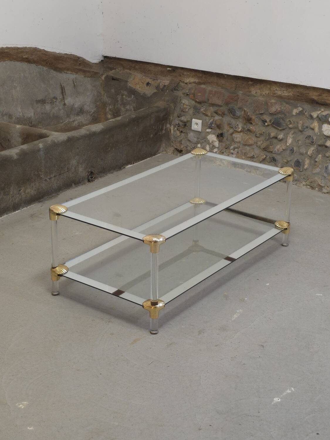 Coffee table, living room table in glass with two tiers, adorned with golden seashells, 1970.