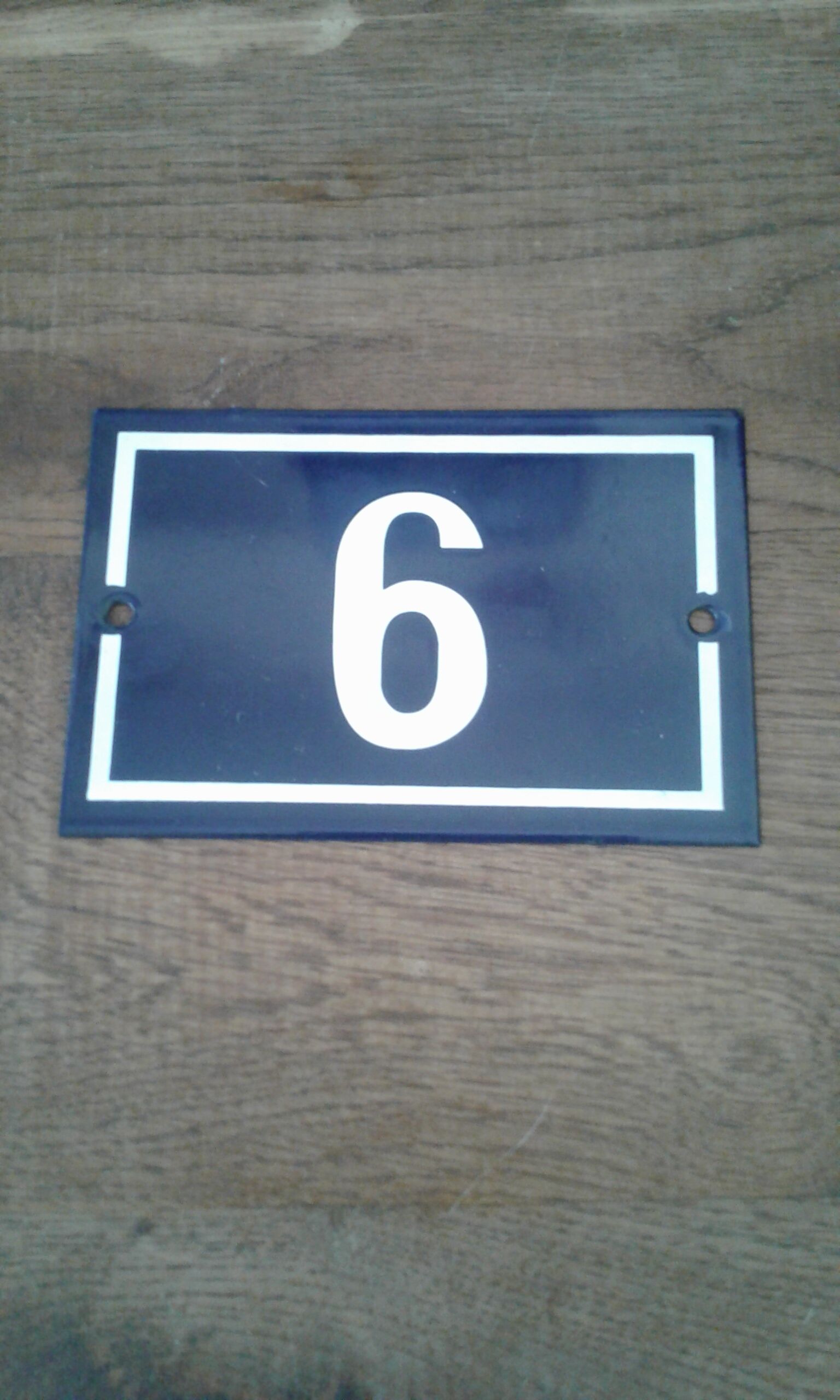 Enamelled street sign bears the number 6