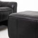 Maison De Sede. Armchair and its ottoman in black leather. 1970s.