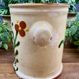 Antique ceramic pot with hand-painted floral decoration.