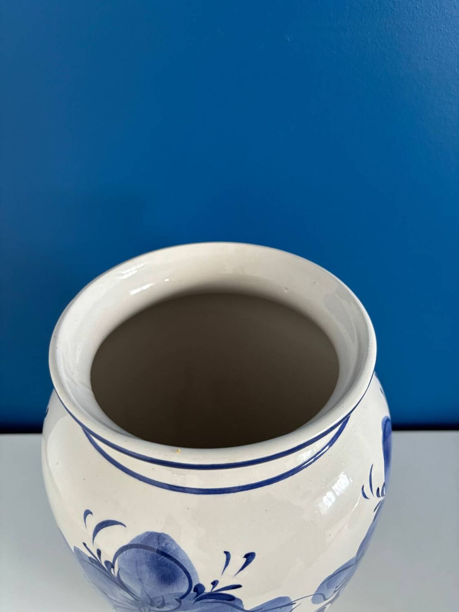 Vintage white and blue ceramic vase with floral pattern