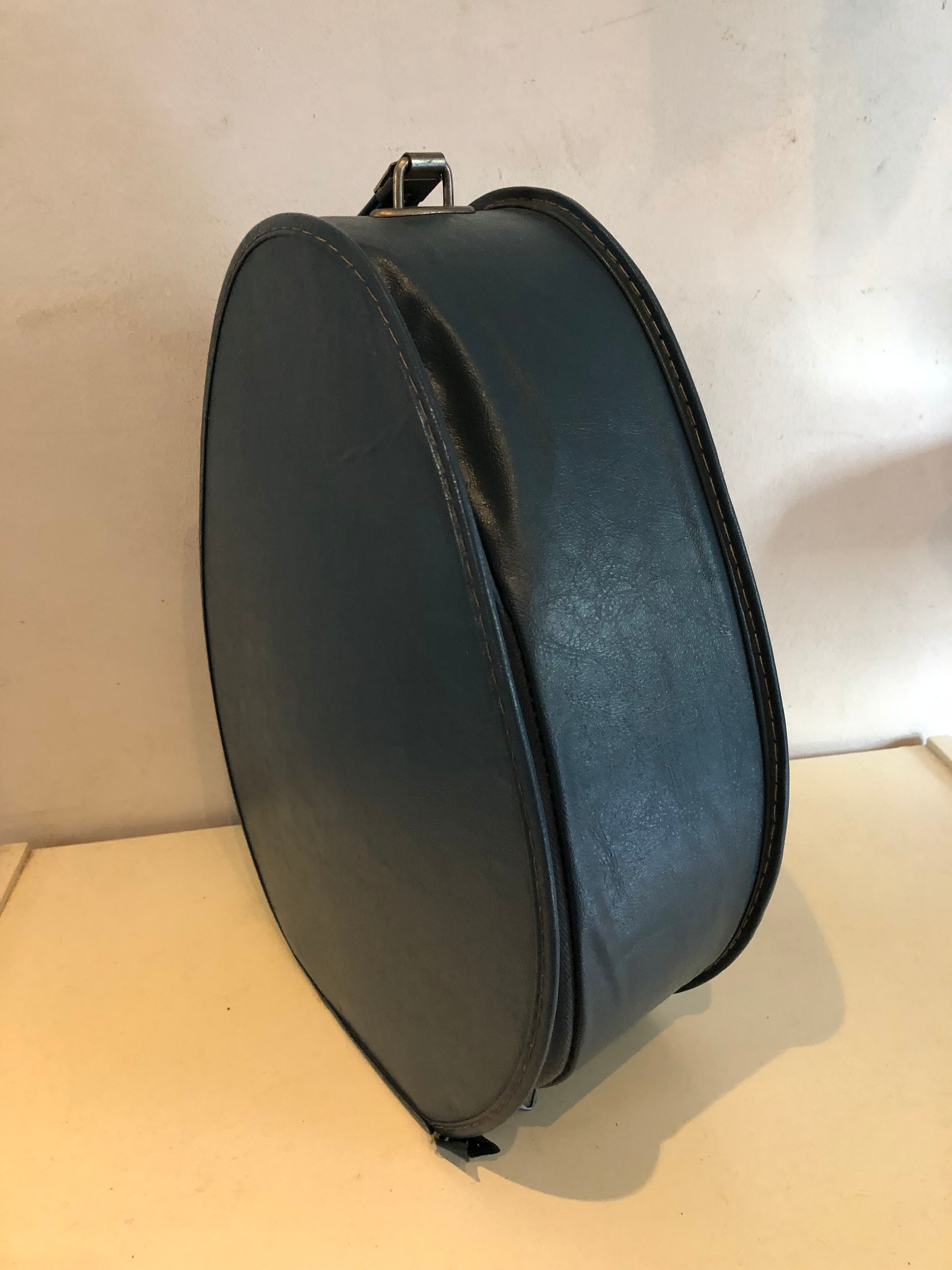 Suitcase has an air hostess hat