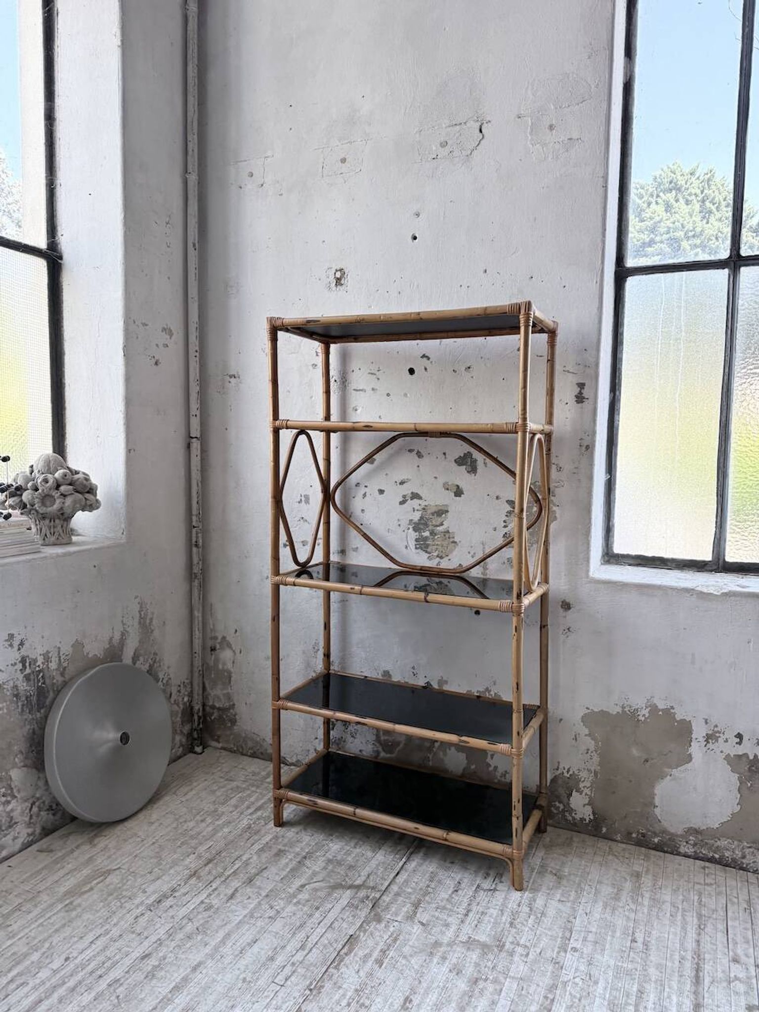 Rattan bookshelf and black glasses