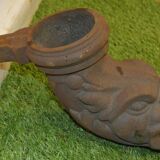 Cast iron gutter downspout in the shape of a dolphin