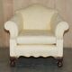 Pair of Edwardian armchairs from 1910 with carved legs and fabric.