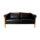Two seater sofa upholstered with black leather and of danish design