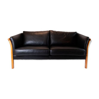 Two seater sofa upholstered with black leather and of danish design