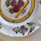 Two earthenware plates with fruits, pears and plums.