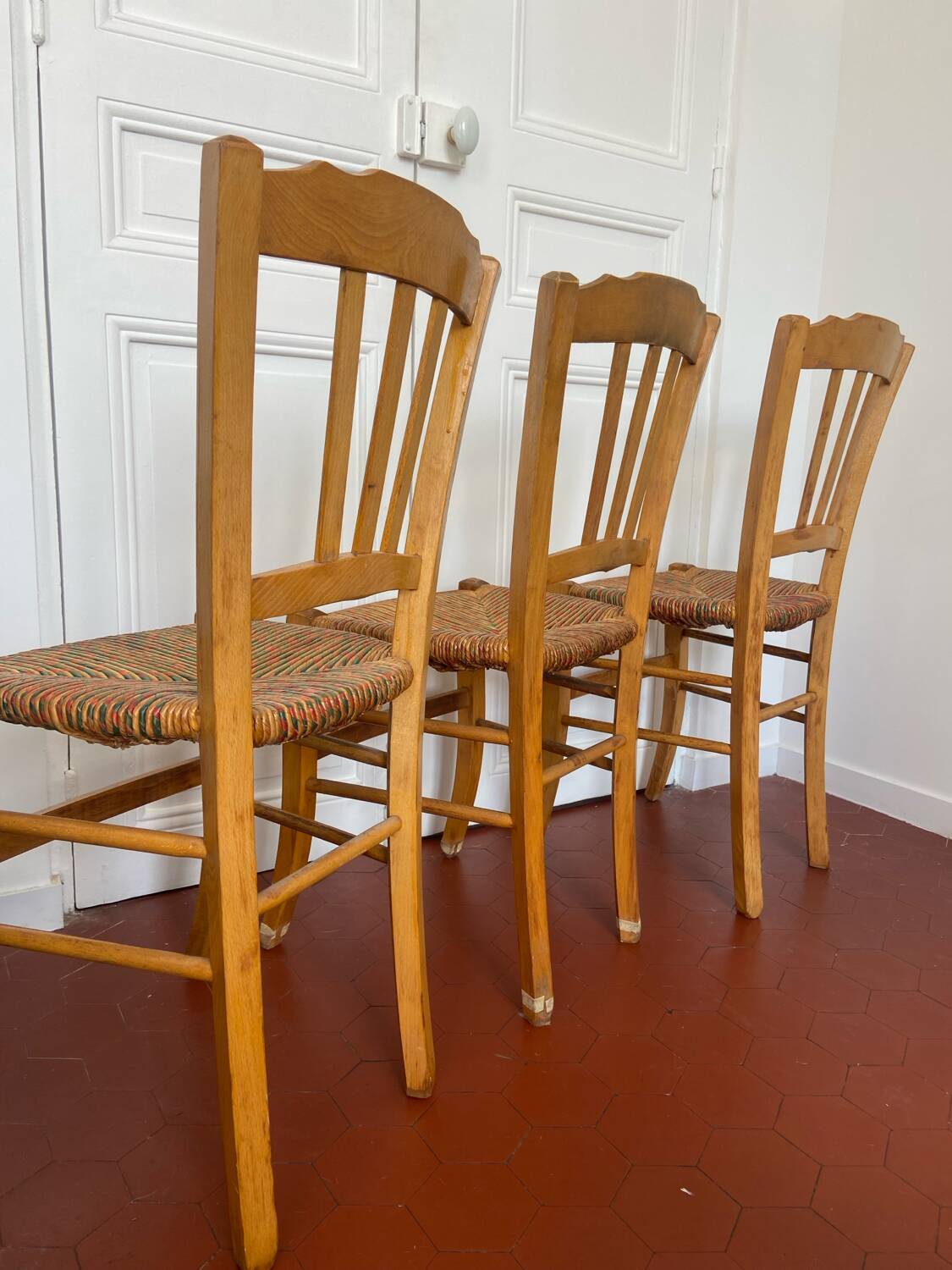 Trio of vintage straw/colored chairs