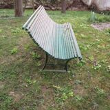 Old metal garden bench with wooden slats