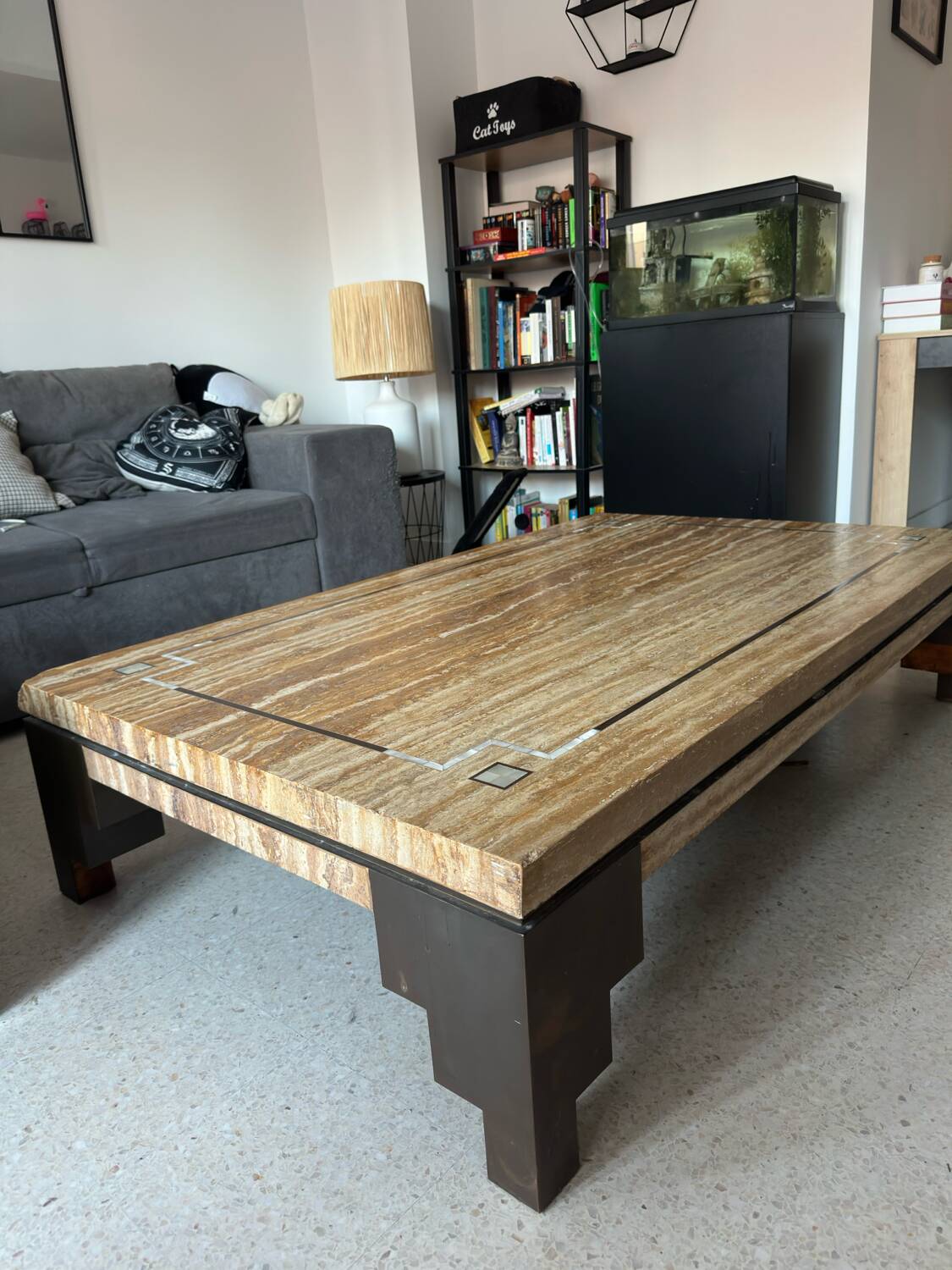 Coffee table in travertine with mother-of-pearl inlays.