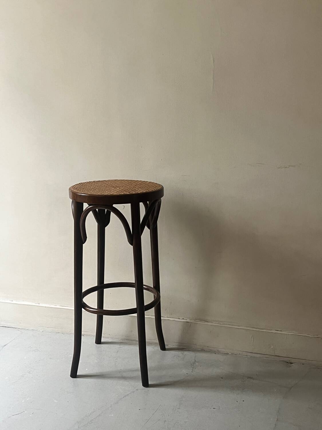 High bistro stool in turned wood and new cane, 1950