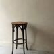 High bistro stool in turned wood and new cane, 1950