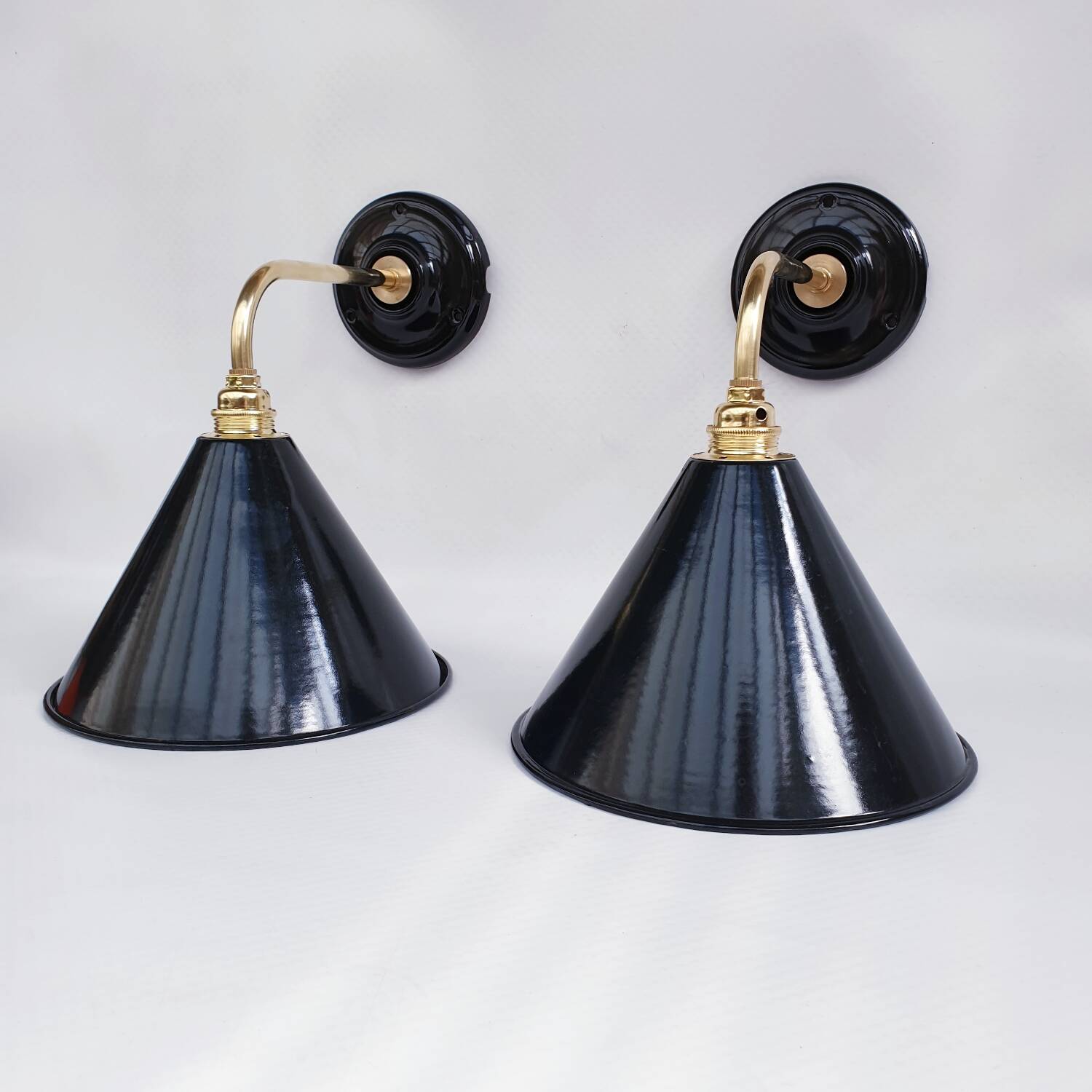 Pair of antique black enamelled sheet metal wall lights