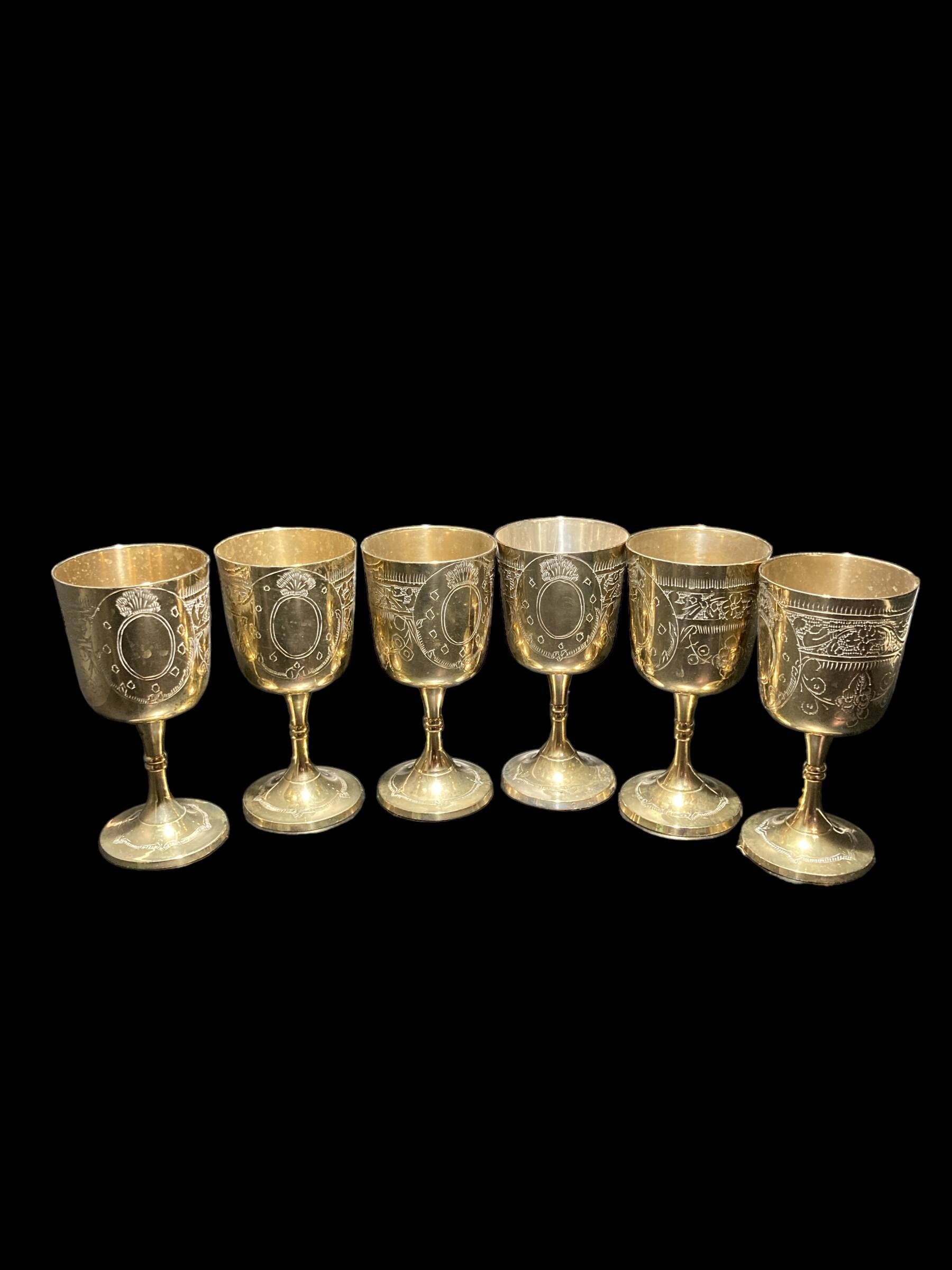 Set of six gold metal glasses