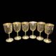 Set of six gold metal glasses