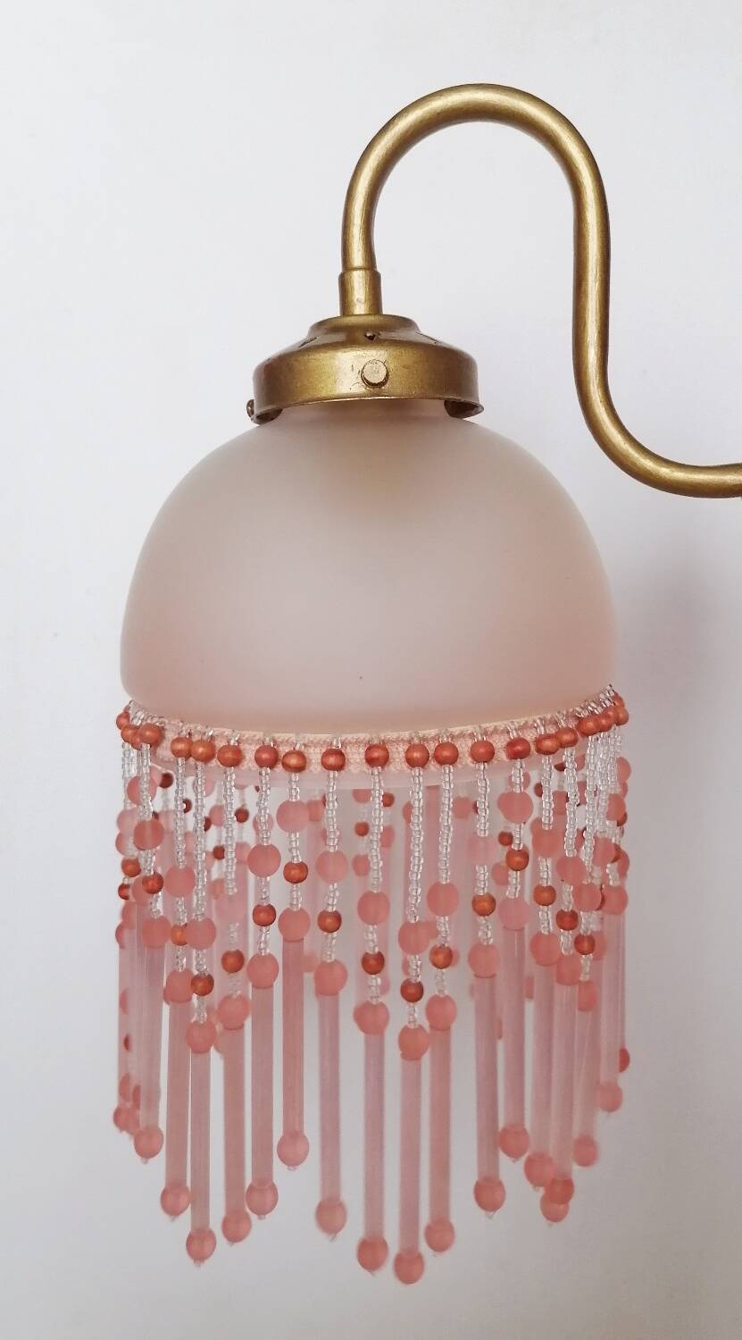 Pink glass wall lamp with garland of pearls
