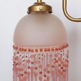 Pink glass wall lamp with garland of pearls