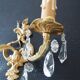 Pair of gilt bronze wall sconces with crystal pendants.