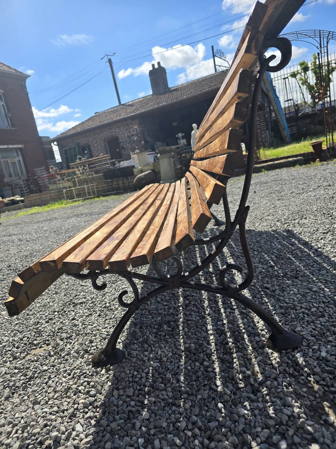 Wooden garden bench with cast iron base