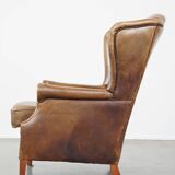 Charming sheep leather wingback armchair with a beautiful patina and excellent seating comfort