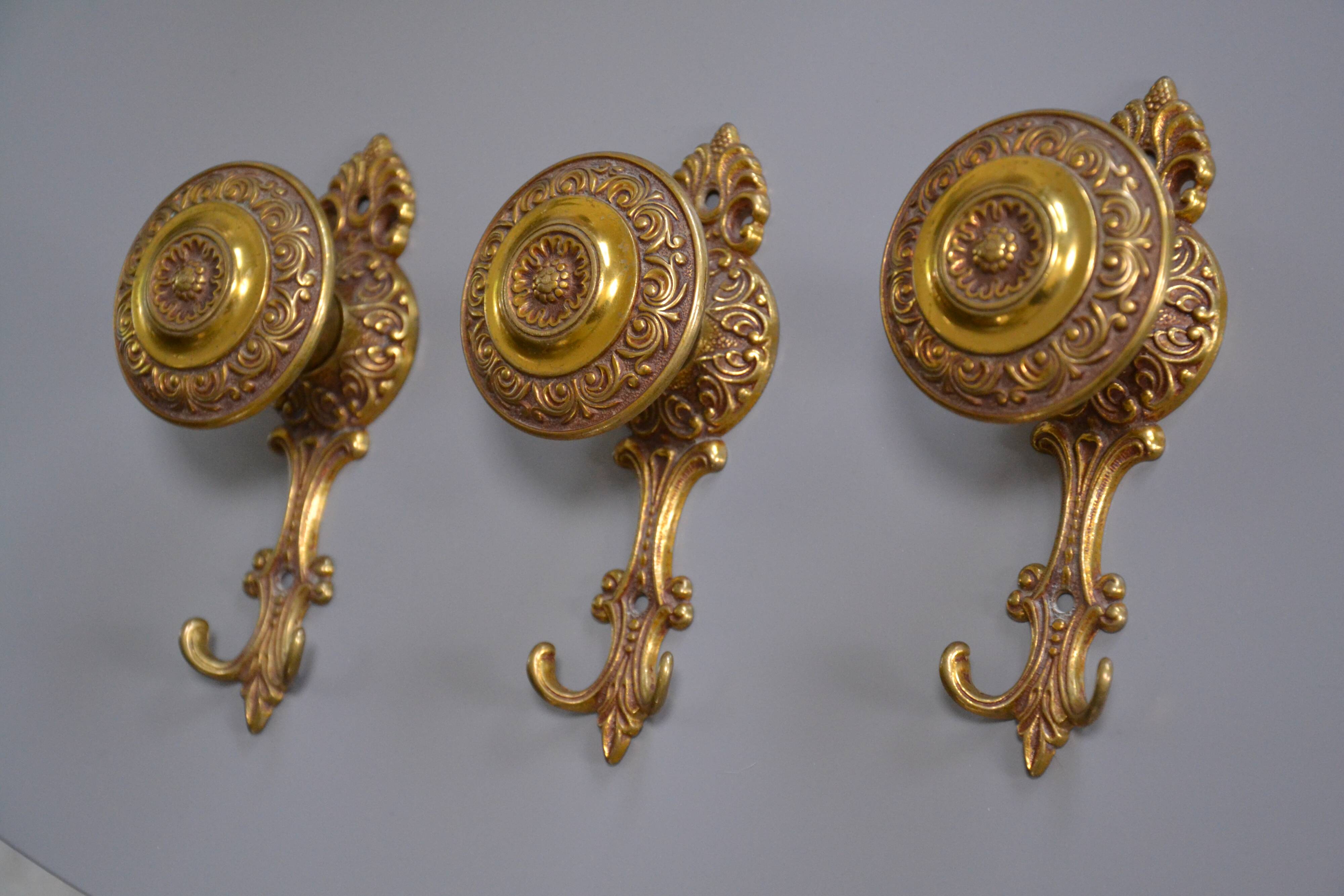 Three coat hooks with brass hook