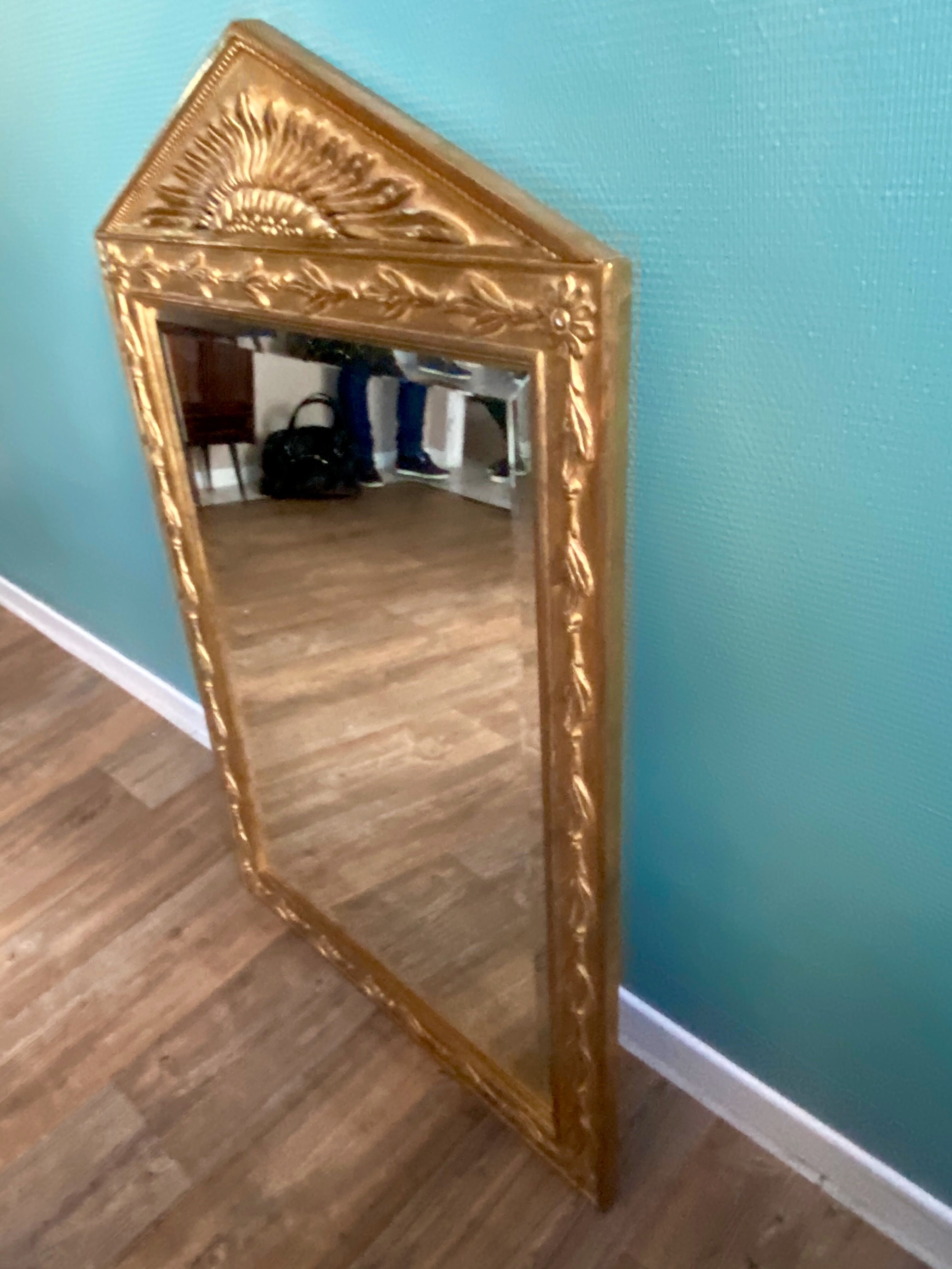 Mirror in gilded wood with a triangle pediment decorated with half sunflowers