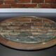Round mirror in a vintage teak wood frame